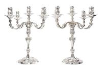 A Pair of Elizabeth II Silver Five-Light Candelabra, Garrard & Co. Ltd., London, 1969, the candle cups of baluster form with rocaille d