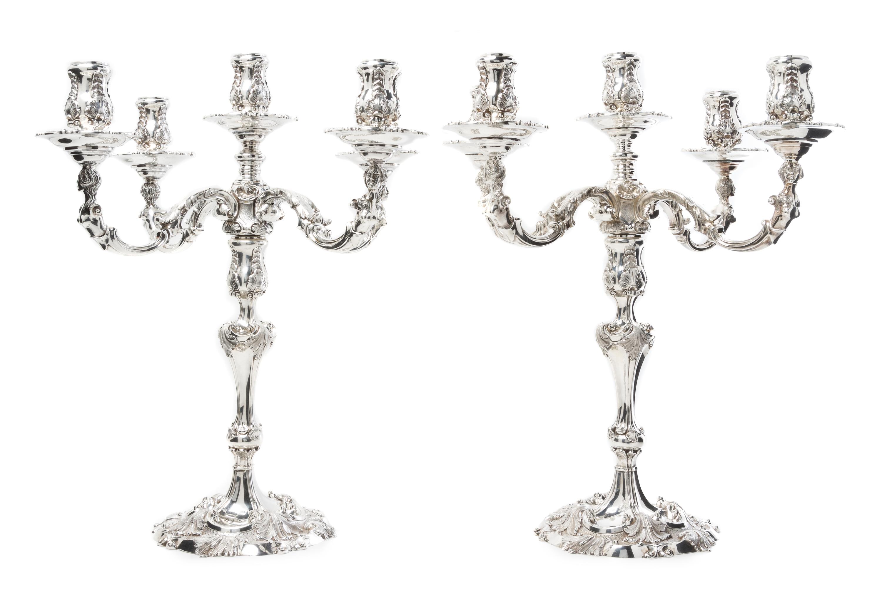 A Pair of Elizabeth II Silver Five-Light Candelabra, Garrard & Co. Ltd., London, 1969, the candle cups of baluster form with rocaille d