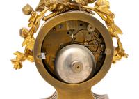 A French Gilt Metal and Porcelain Clock