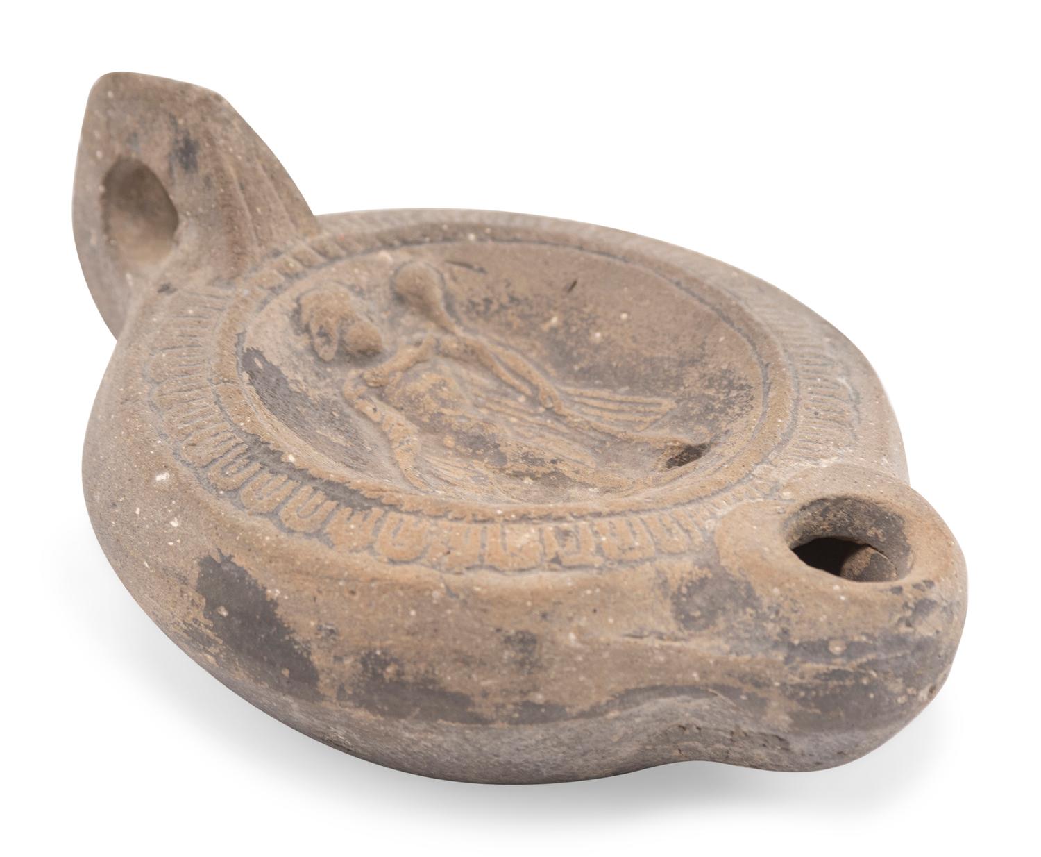 A Roman Discus Lamp Depicting Dionysos Holding a Thyrsos and a Bunch of Grapes