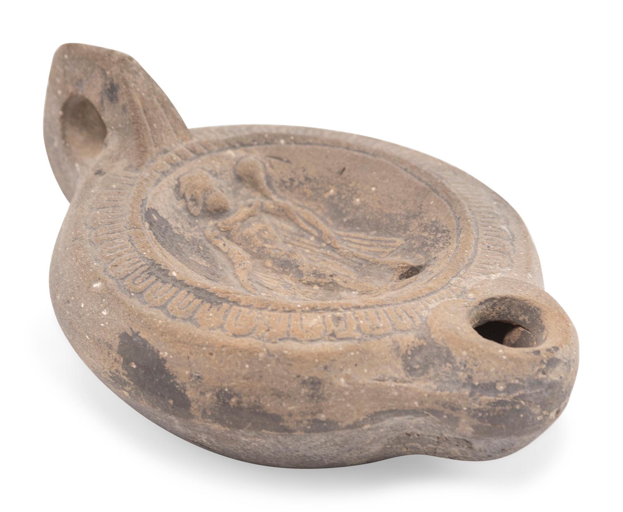 A Roman Discus Lamp Depicting Dionysos Holding a Thyrsos and a Bunch of Grapes