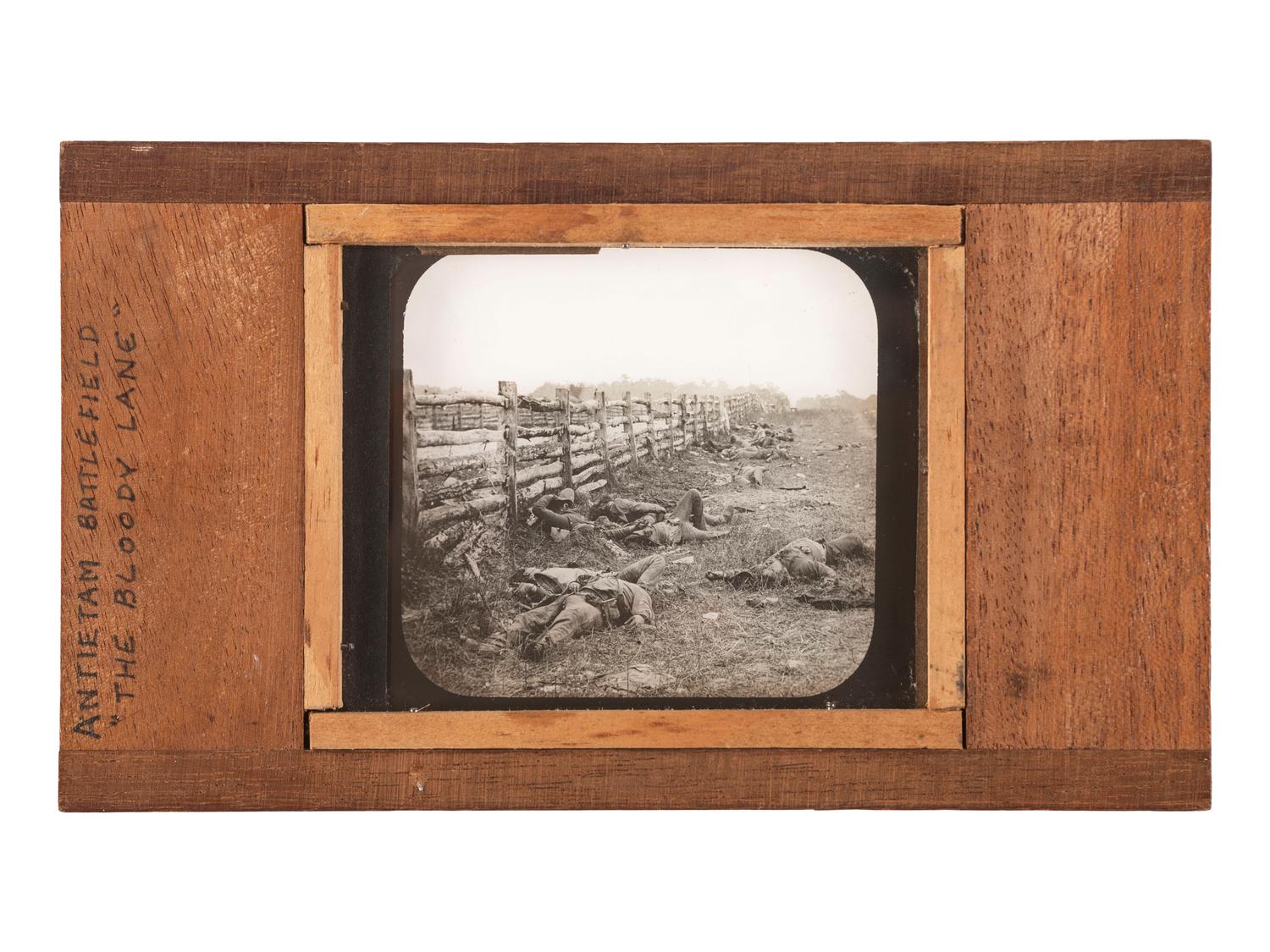 [CIVIL WAR]. GARDNER, Alexander, photographer. A group of 2 images of fallen Confederate soldiers at Antietam, including stereoview and magic lantern slide. Hartford, CT: Taylor & Huntington.