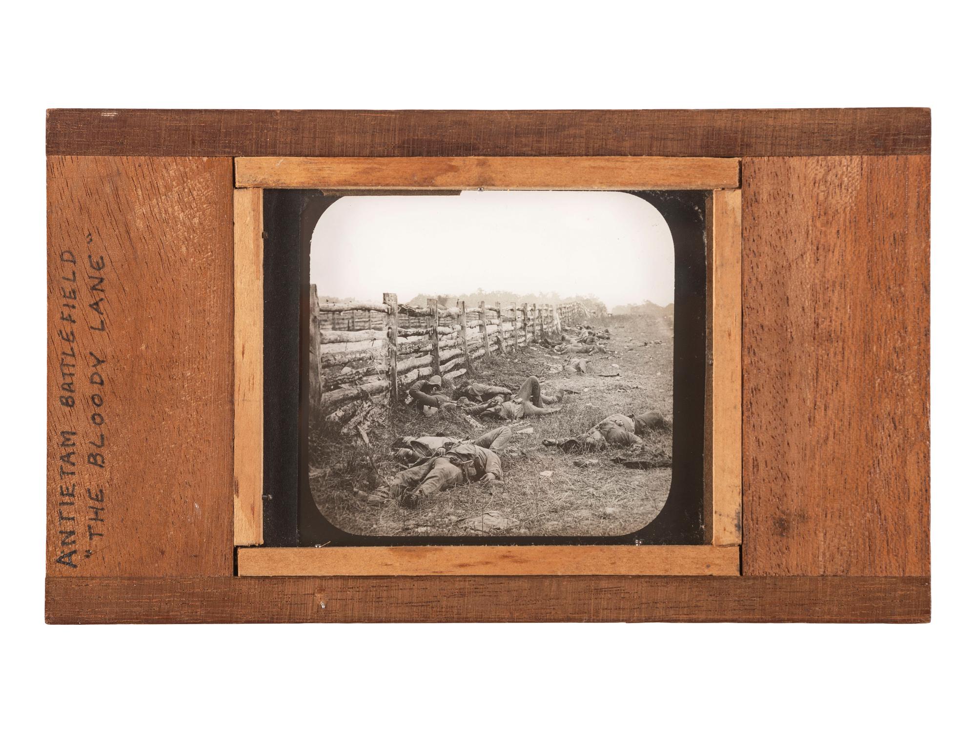 [CIVIL WAR]. GARDNER, Alexander, photographer. A group of 2 images of fallen Confederate soldiers at Antietam, including stereoview and magic lantern slide. Hartford, CT: Taylor & Huntington.