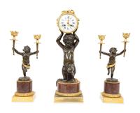 A French Gilt and Patinated Bronze and Rouge Marble Clock Garniture