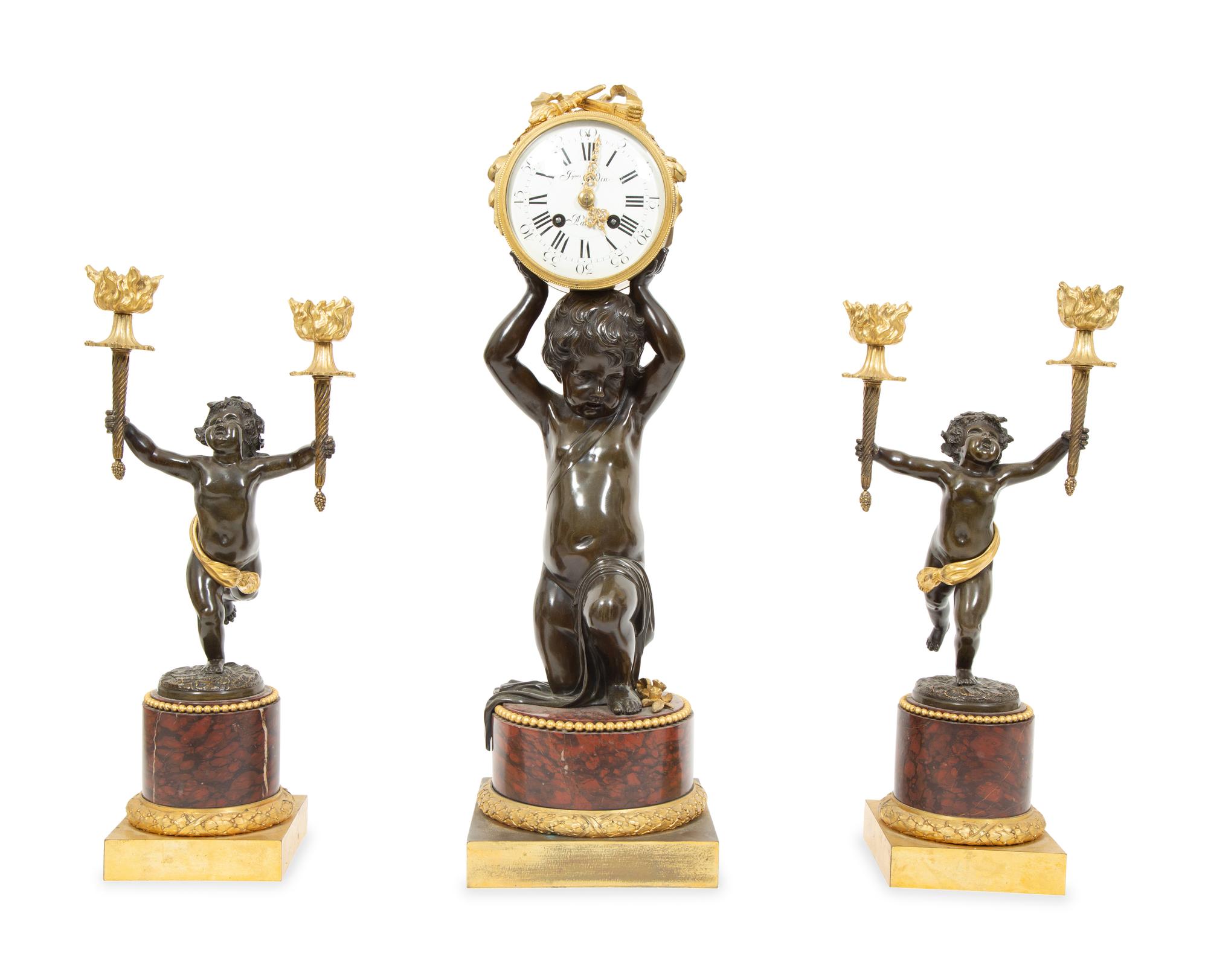 A French Gilt and Patinated Bronze and Rouge Marble Clock Garniture