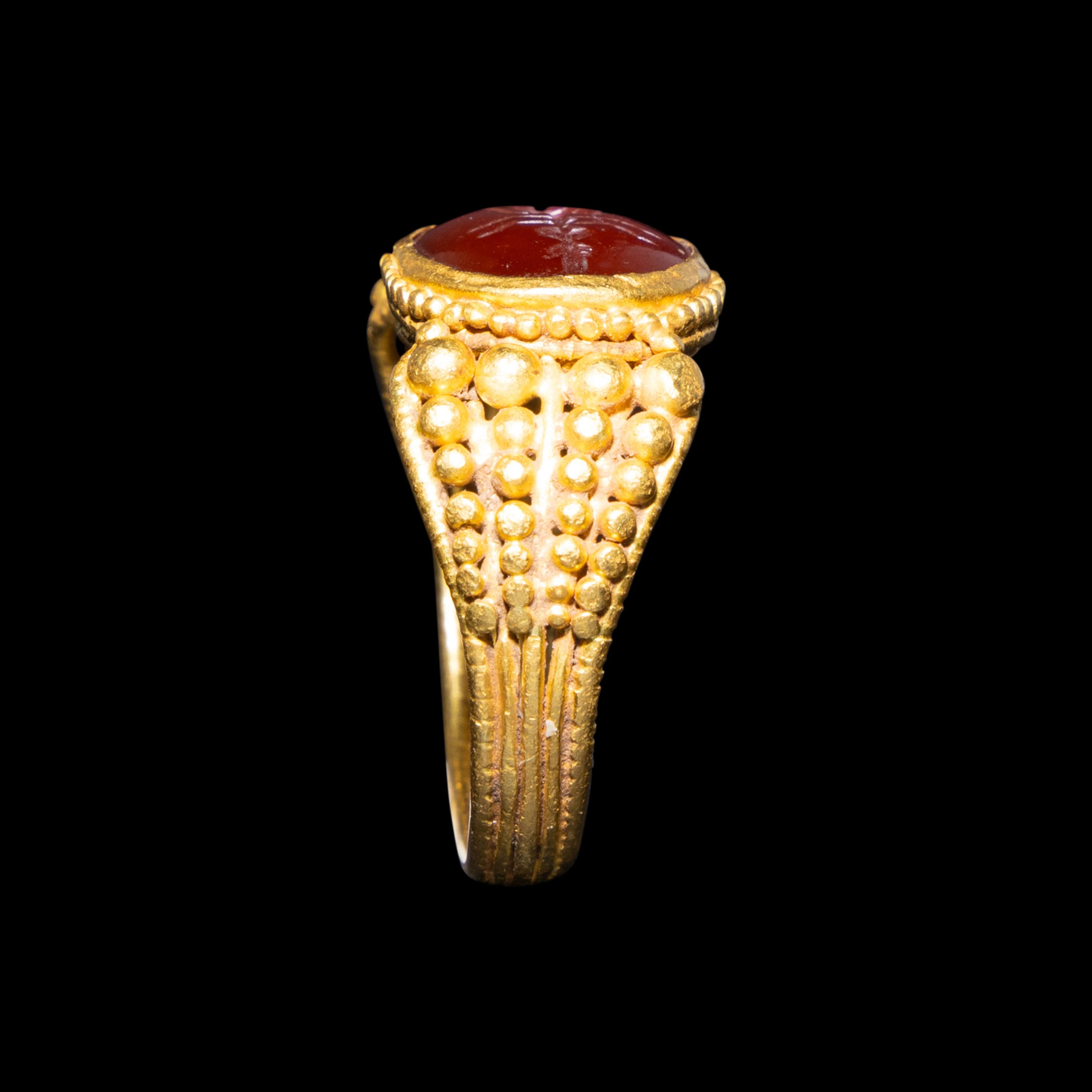 A Late Roman Gold and Carnelian Ring with an Ant Carrying an Ear of Wheat