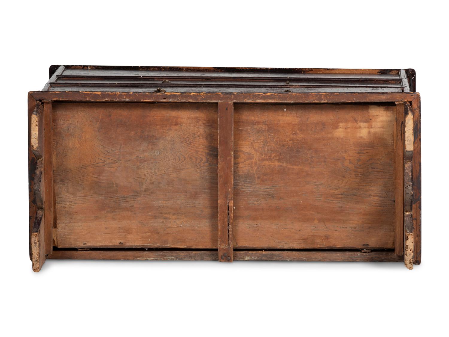 A Rare Pilgrim Century Black Painted Pine One-Drawer 'M' Chest