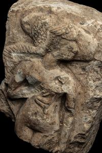 An Egyptian Limestone Fragment of a Mother Nursing her Child