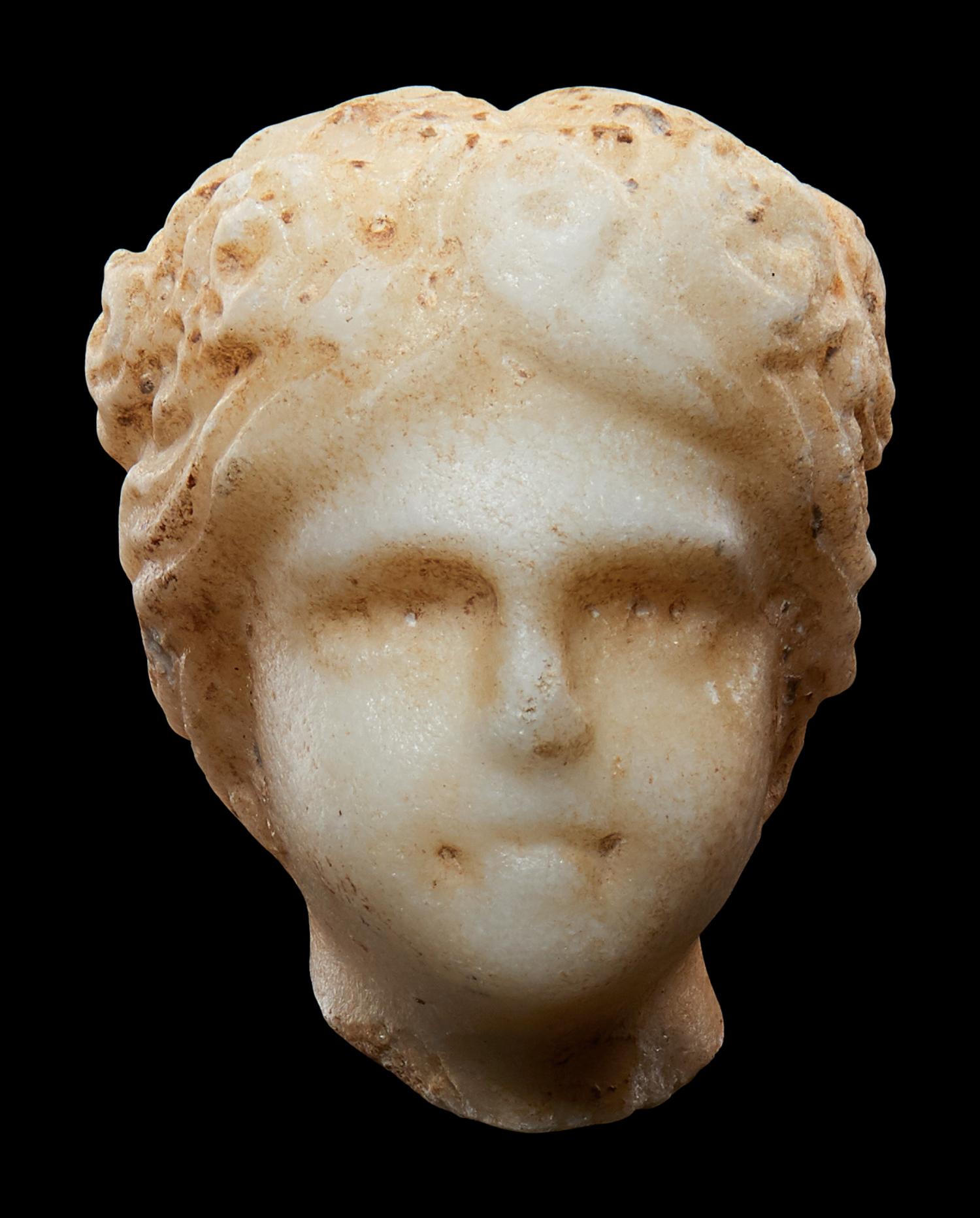 A Roman Marble Head of a Muse, Possibly Flora