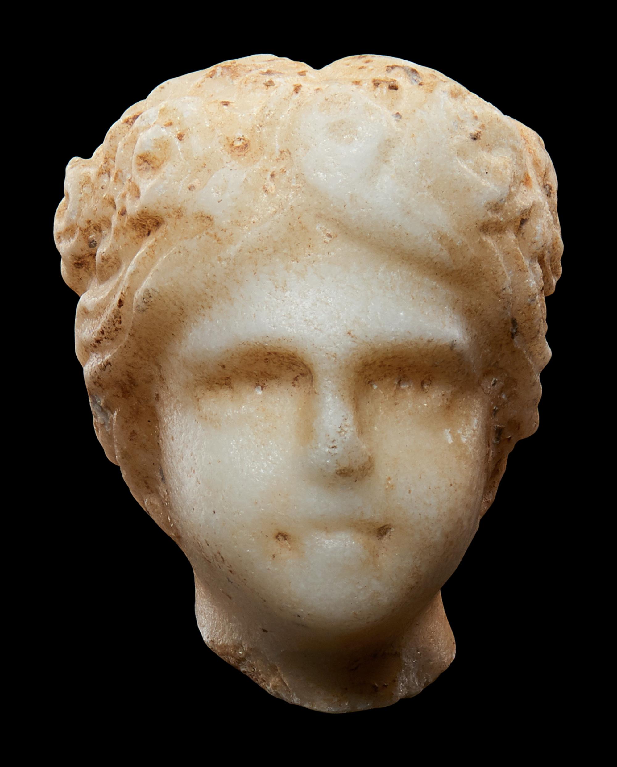 A Roman Marble Head of a Muse, Possibly Flora