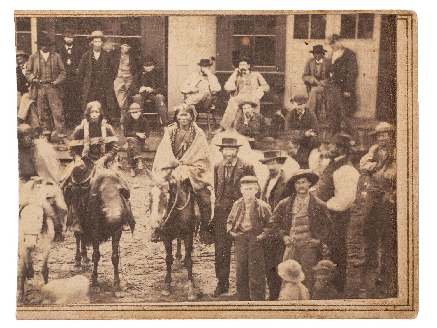 [NATIVE AMERICANS]. [MCKENNY, A.S., photographer]. CDV of street scene featuring Ute Indians on horseback. [Black Hawk, Colorado Territory], Ca 1870.