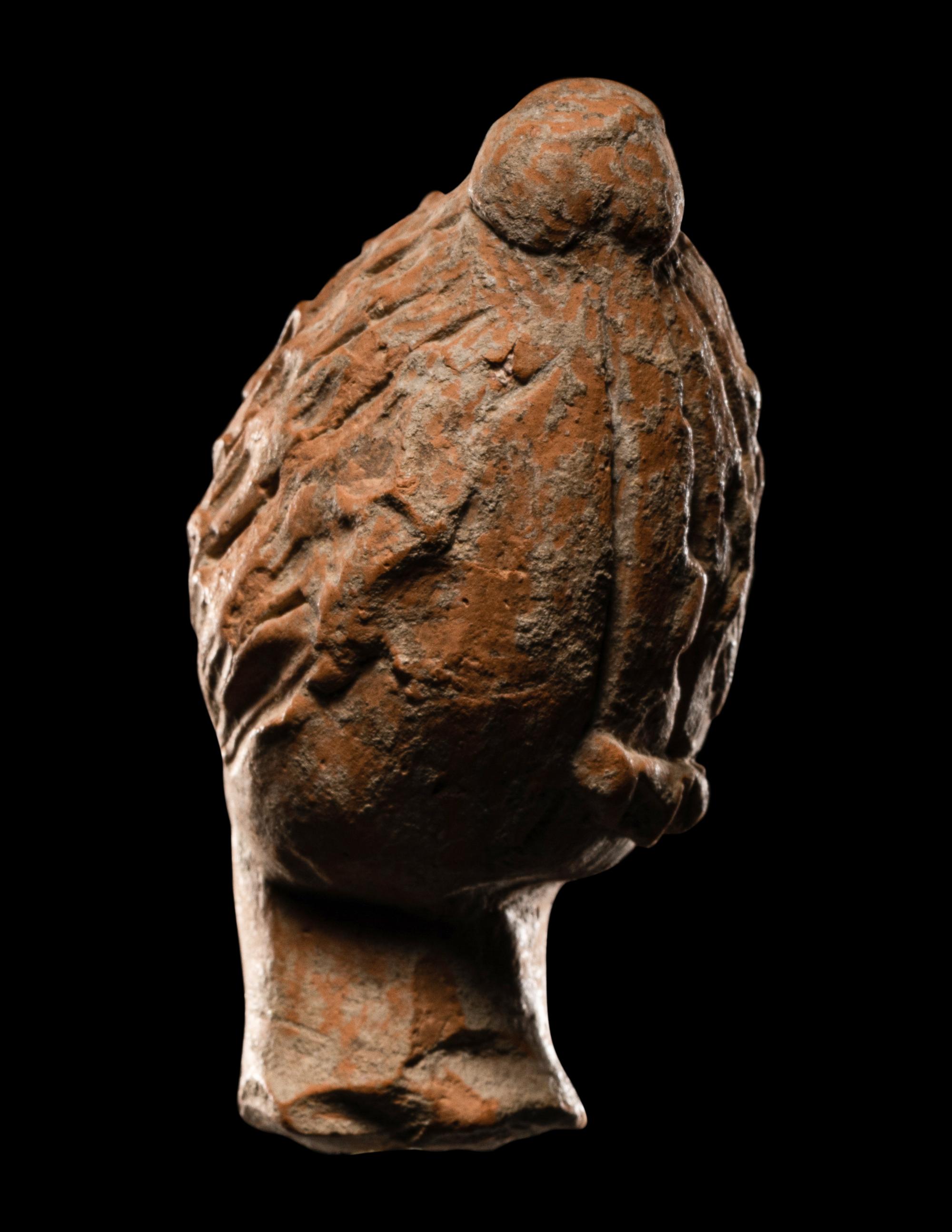 A Greek Terracotta Female Head with Melon Coiffure