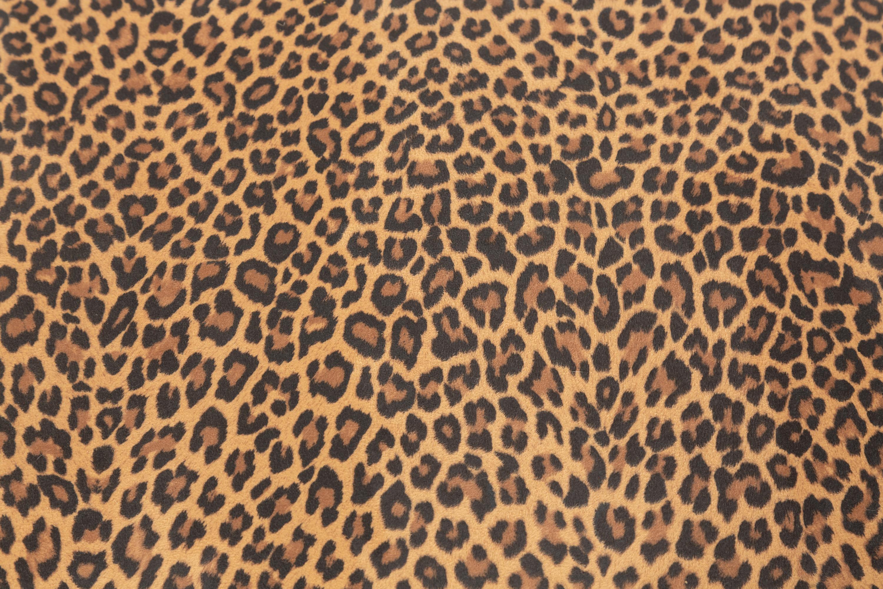 A Louis XIV Carved Walnut Tabouret with Leopard Print Upholstery