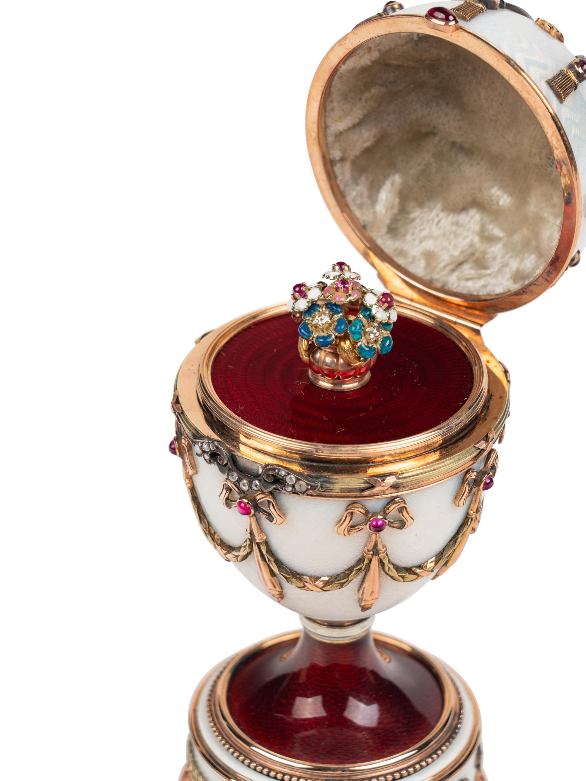 A 14 Karat Vari-Color Gold, Silver, Guilloché Enamel, Diamond, Pearl, and Cabochon Jewel-Mounted Surprise Egg
