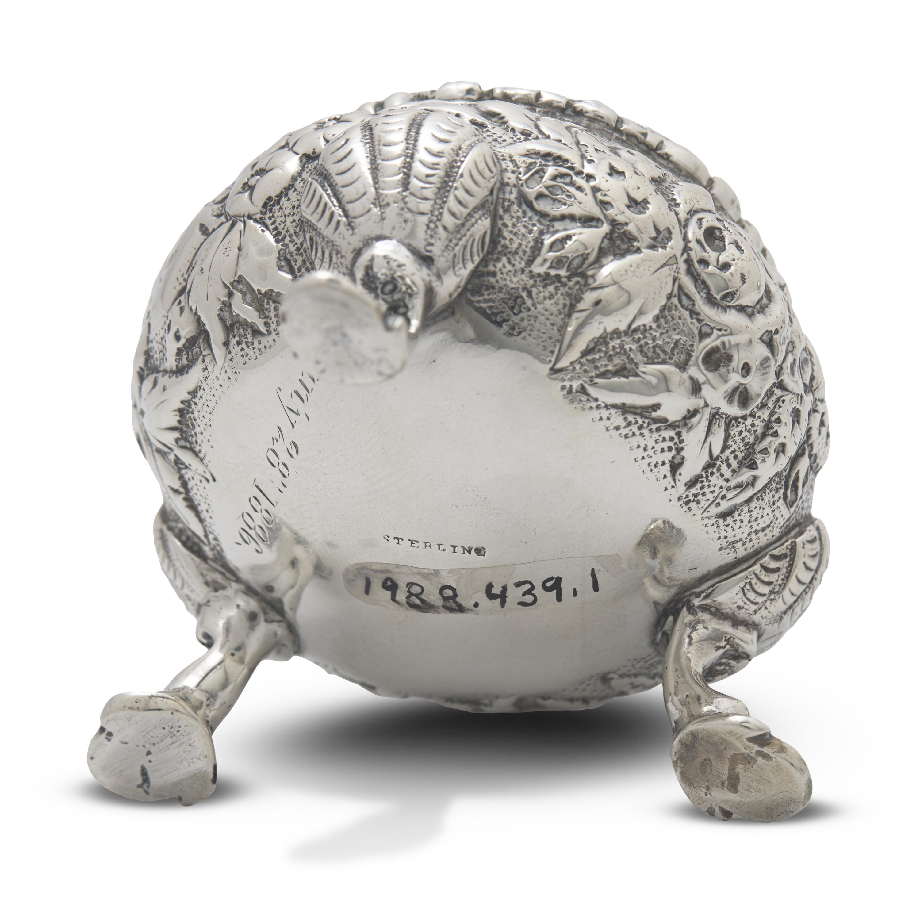 A Pair of Sterling Silver Floral Repousse Salt Cellars