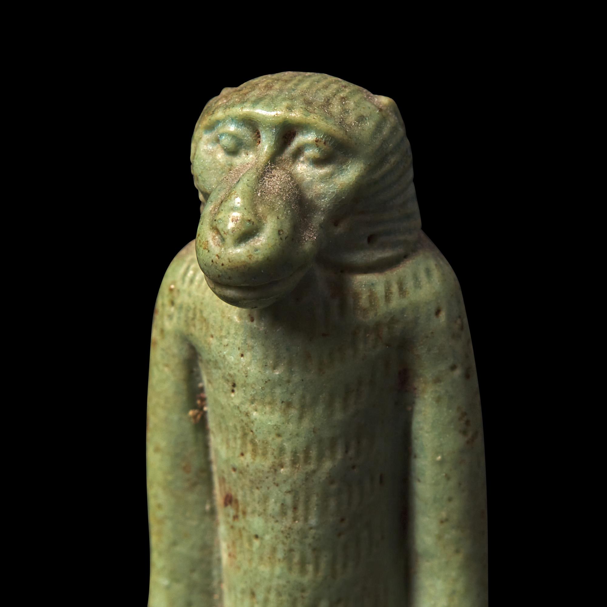 An Egyptian Green Faience Baboon Amulet