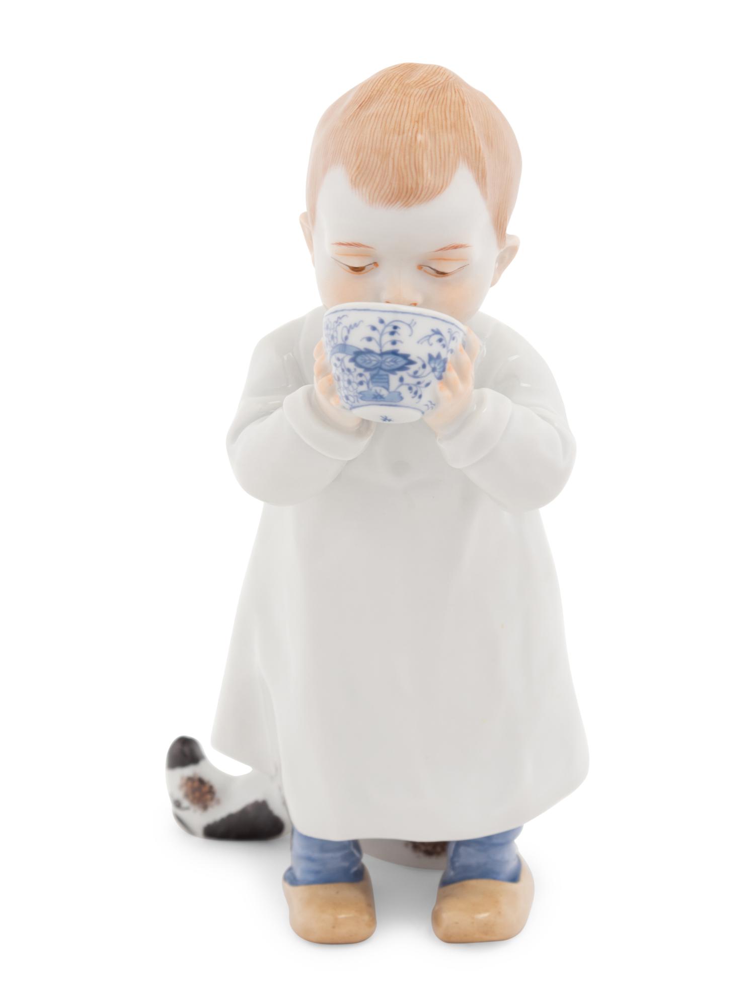 A Meissen Porcelain Figure of a Boy Drinking From a Blue Onion Bowl
