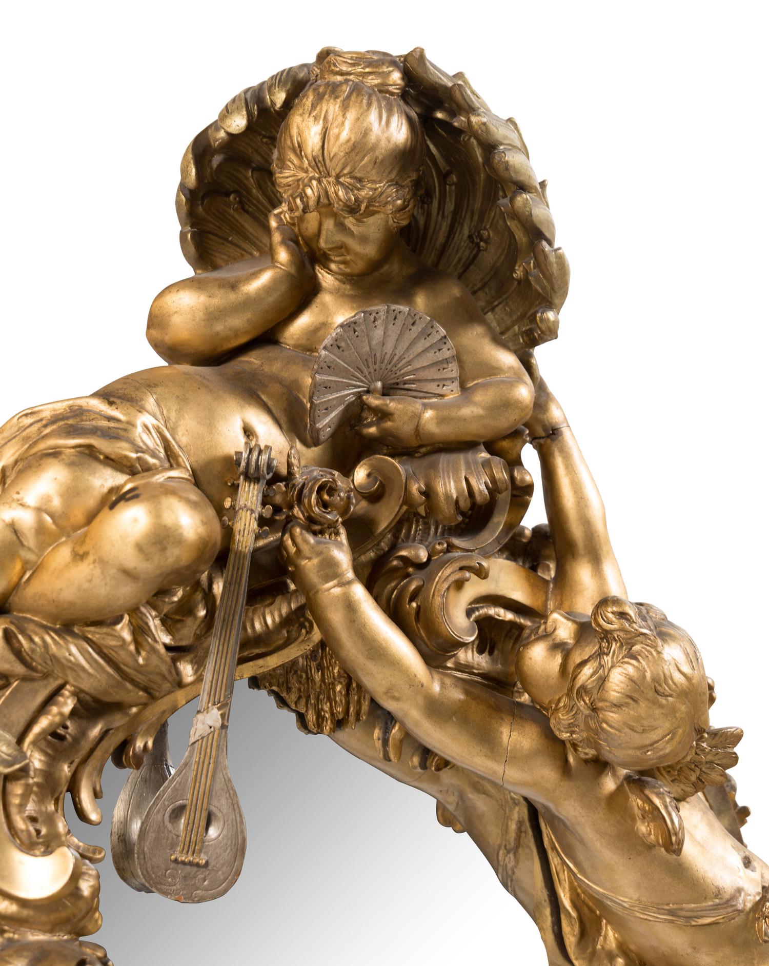 A Baroque Style Gilt and Silvered Composition Mirror