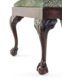 A Set of Eight George III Carved Mahogany Ribbon-Back Dining Chairs