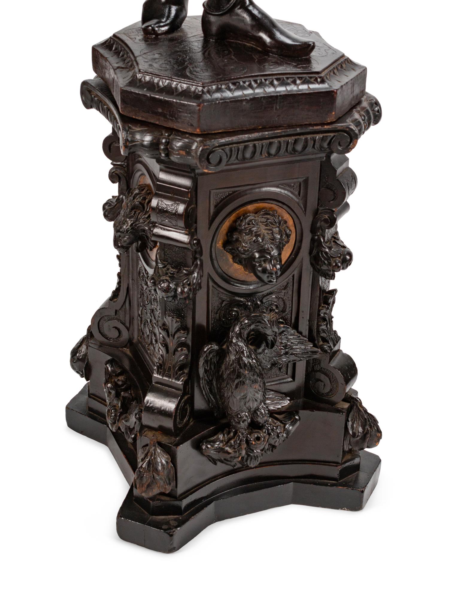 A Large Pair of English Parcel-Gilt and Stained Wood Figural Torchères on Stands