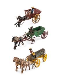 A Group of Three Cast Iron Horse-Drawn Carts