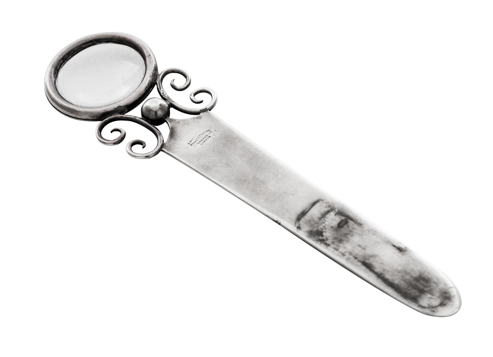 An Edwardian Silver Paper Knife, Andrew Barrett & Sons, London, 1902, having a circular handle inset with a magnifier and applied with