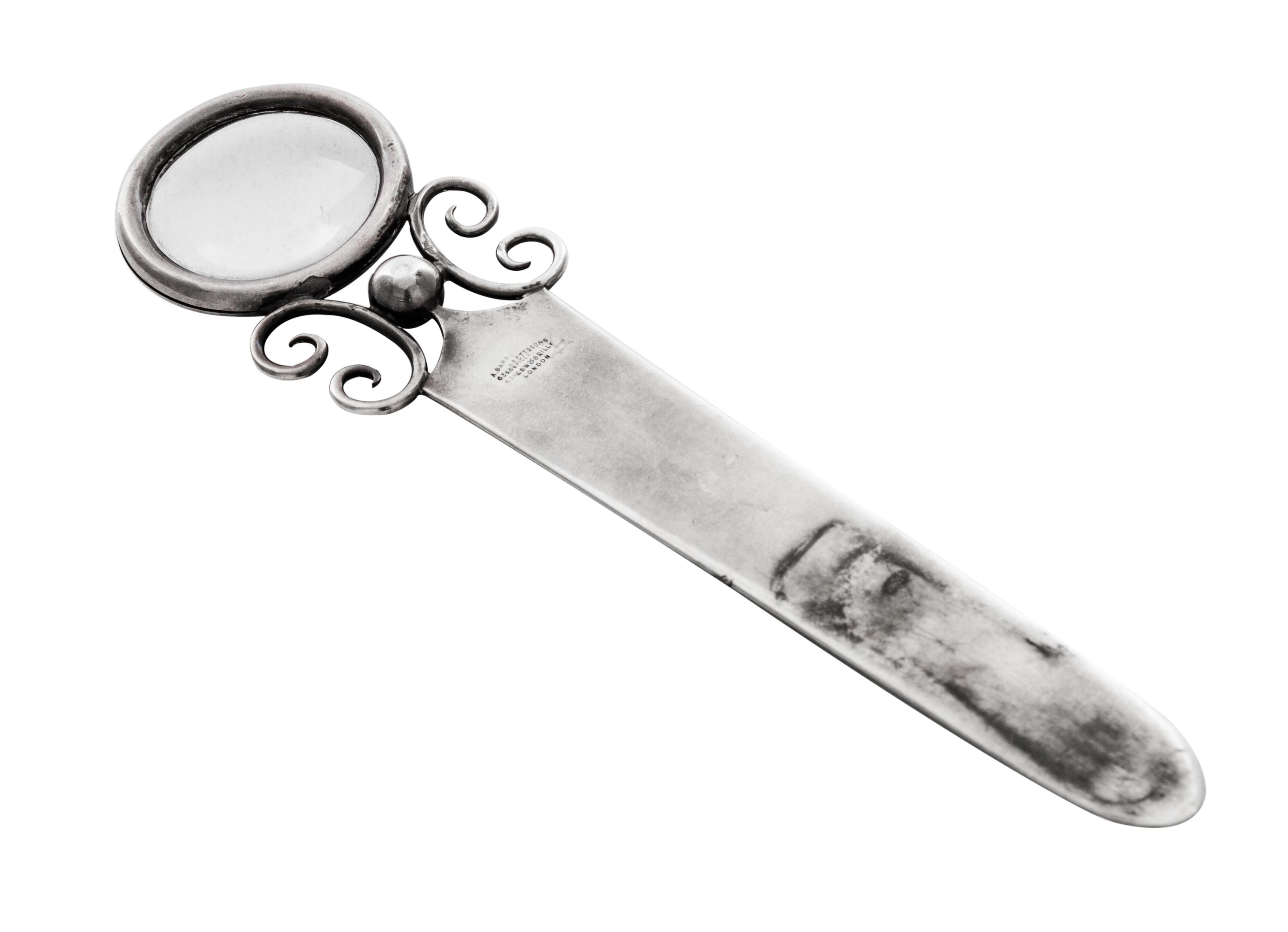 An Edwardian Silver Paper Knife, Andrew Barrett & Sons, London, 1902, having a circular handle inset with a magnifier and applied with