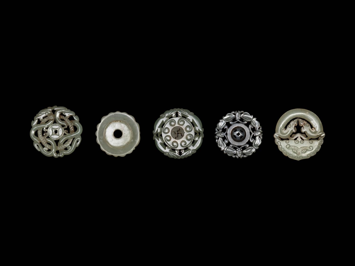 Five Chinese Pale Celadon Jade Carved and Reticulated Circular Pendants
