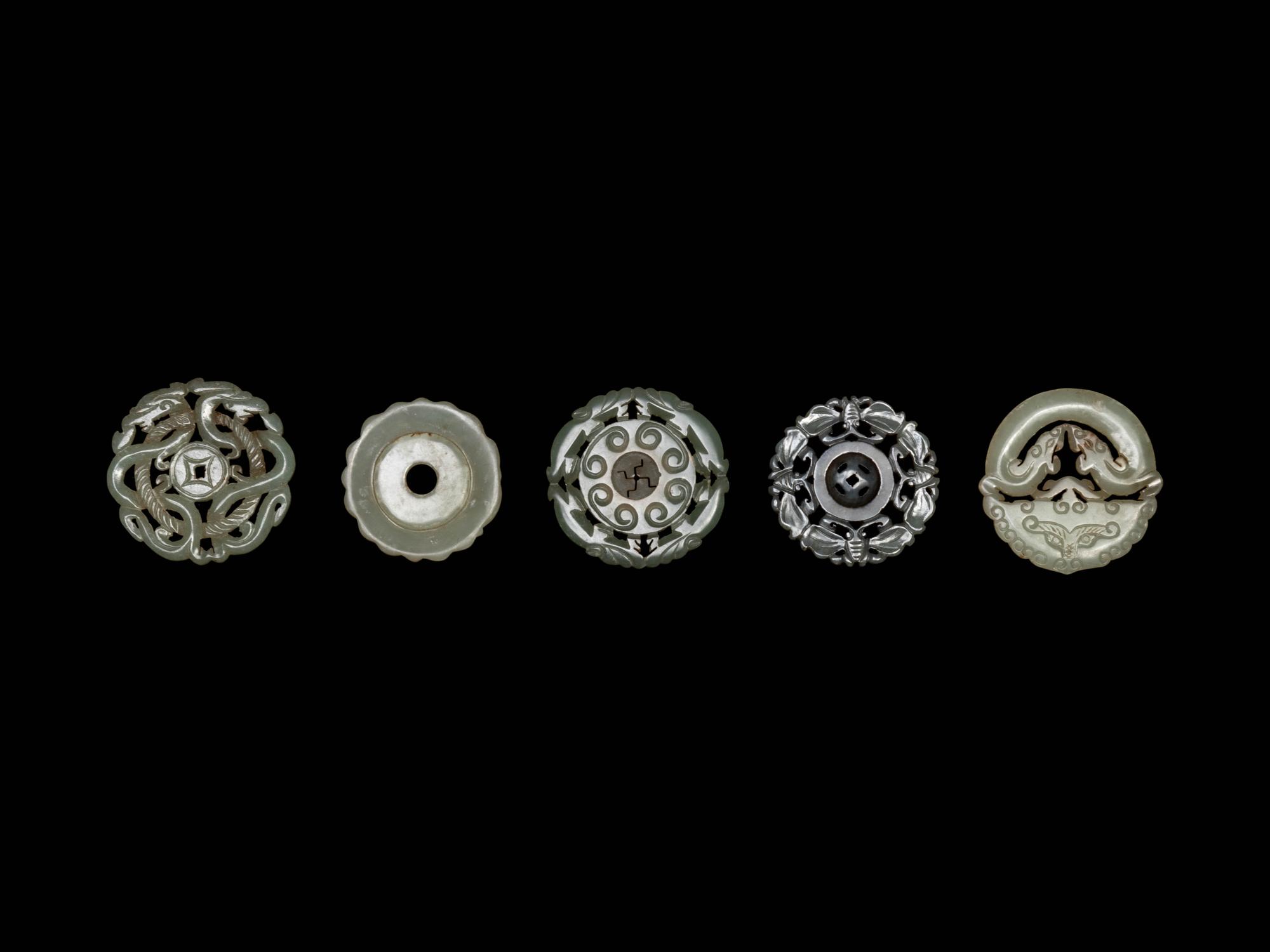 Five Chinese Pale Celadon Jade Carved and Reticulated Circular Pendants
