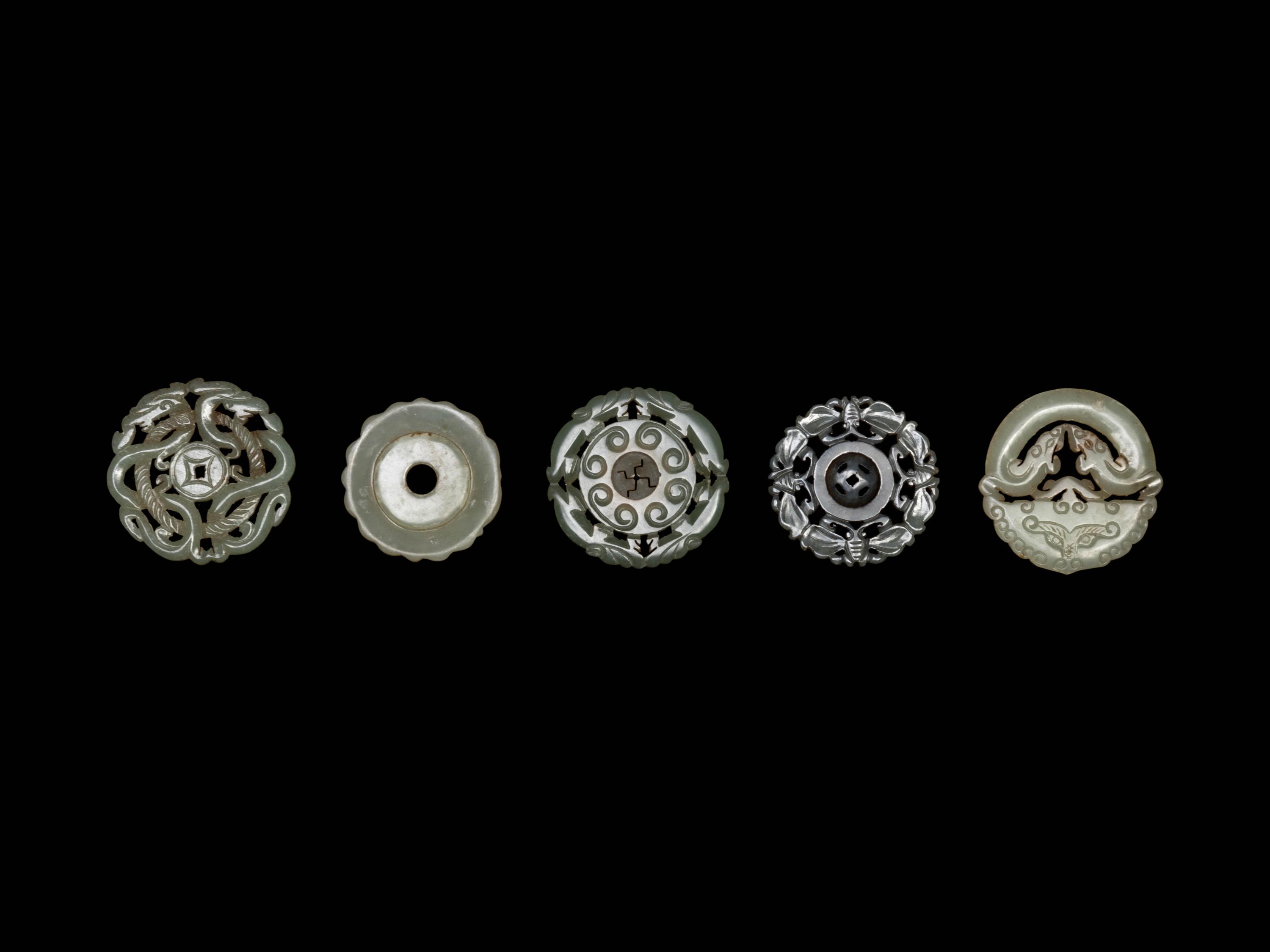 Five Chinese Pale Celadon Jade Carved and Reticulated Circular Pendants