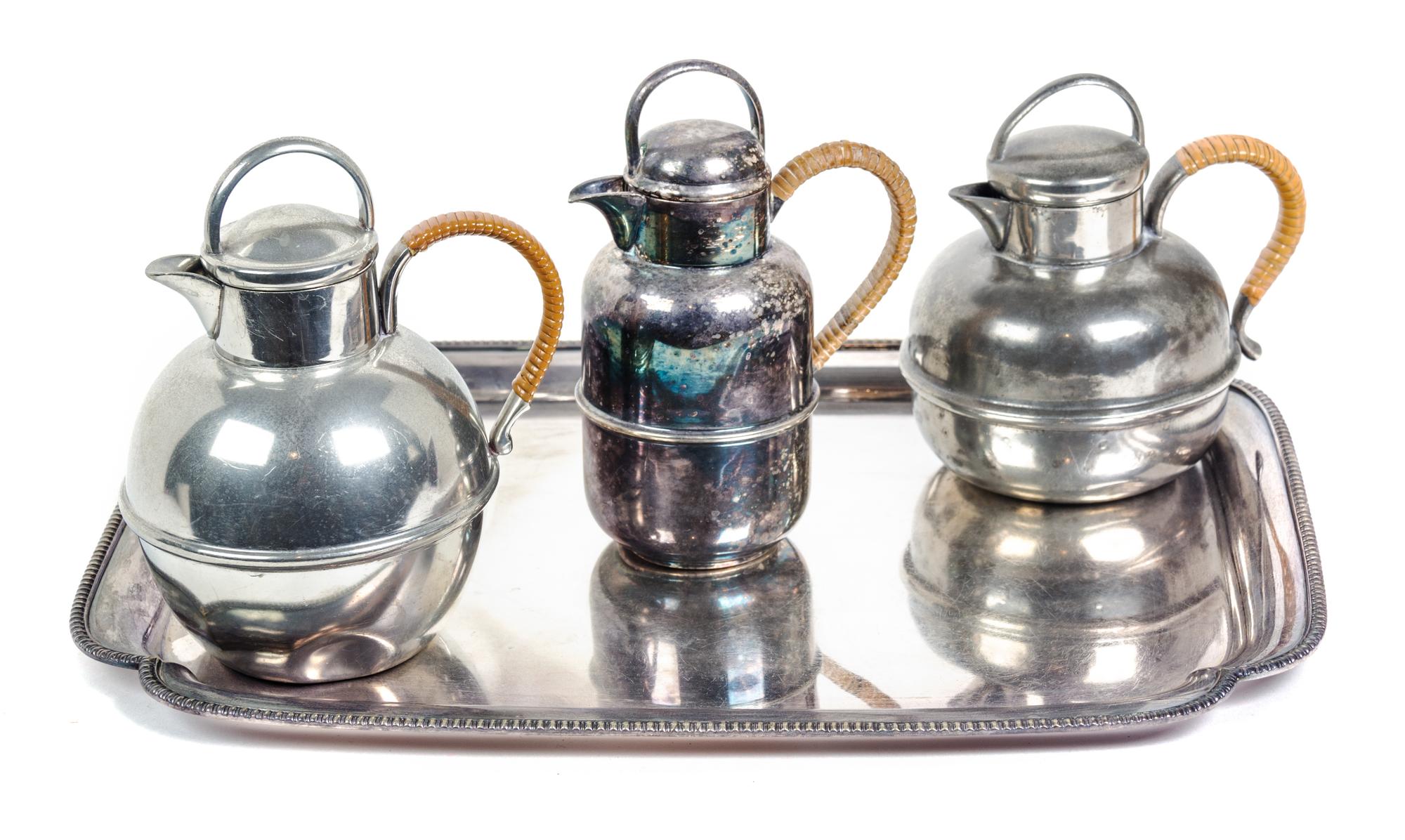 Three Wicker Handled Teapots and a Silverplate Tray Length of tray 14 1/4 inches. — 20TH CENTURY