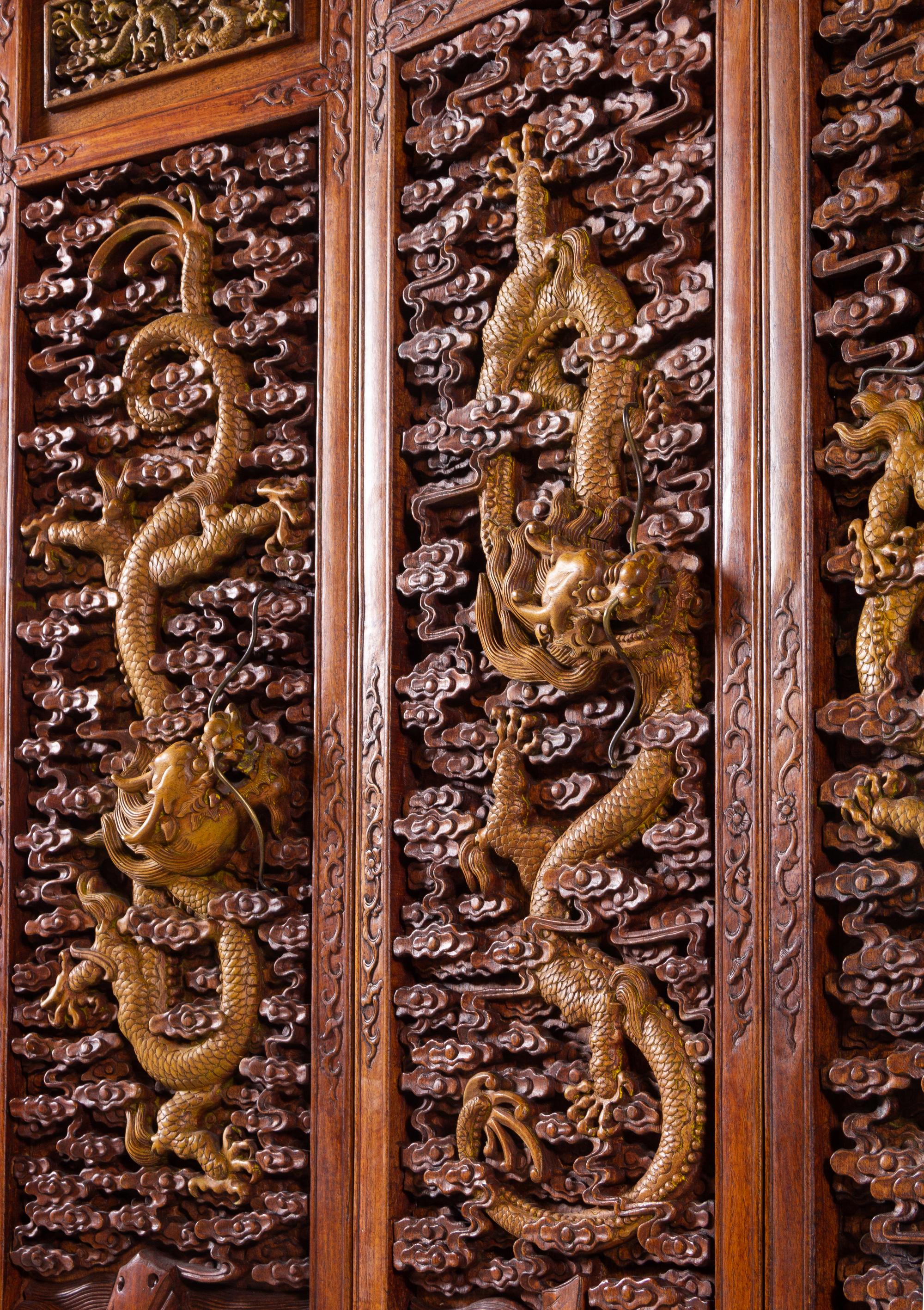 A Large Chinese Export Carved Hardwood 'Dragon and Clouds' Screen