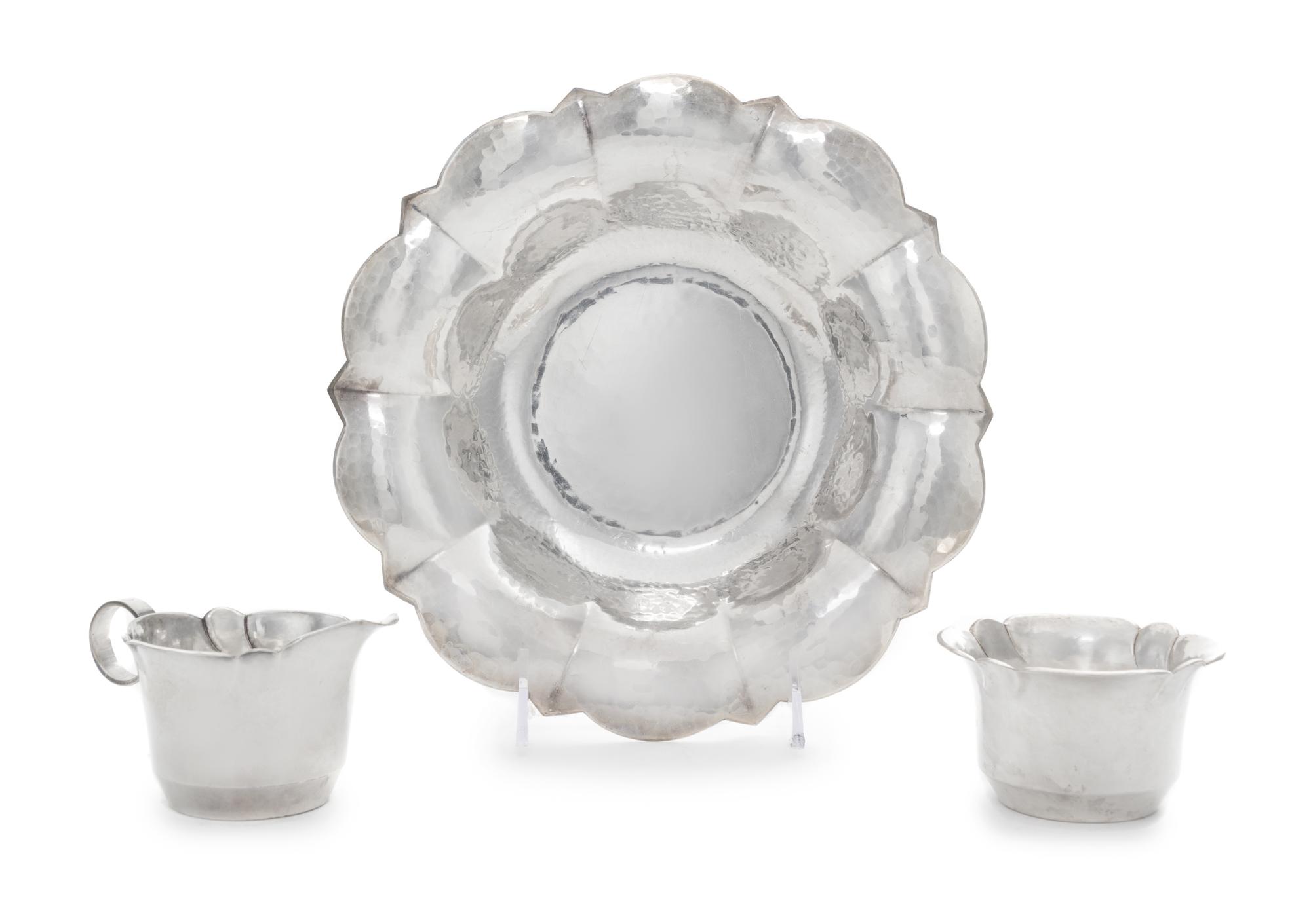 A German Silver-Plate Dish and Matching Creamer and Sugar Bowl, Maker's Mark Two Horse Heads, 20th Century, each having a spot-hammered