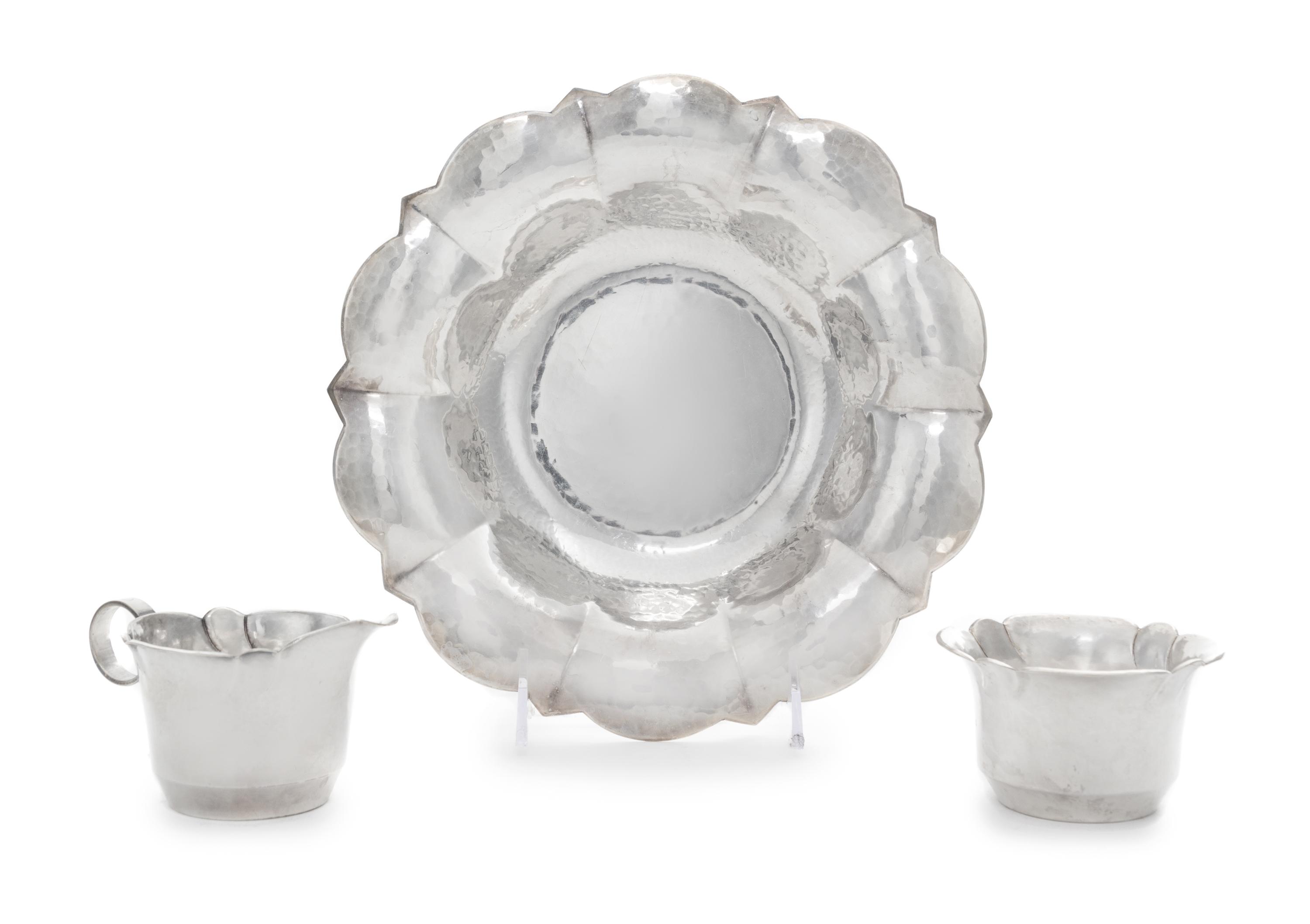A German Silver-Plate Dish and Matching Creamer and Sugar Bowl, Maker's Mark Two Horse Heads, 20th Century, each having a spot-hammered