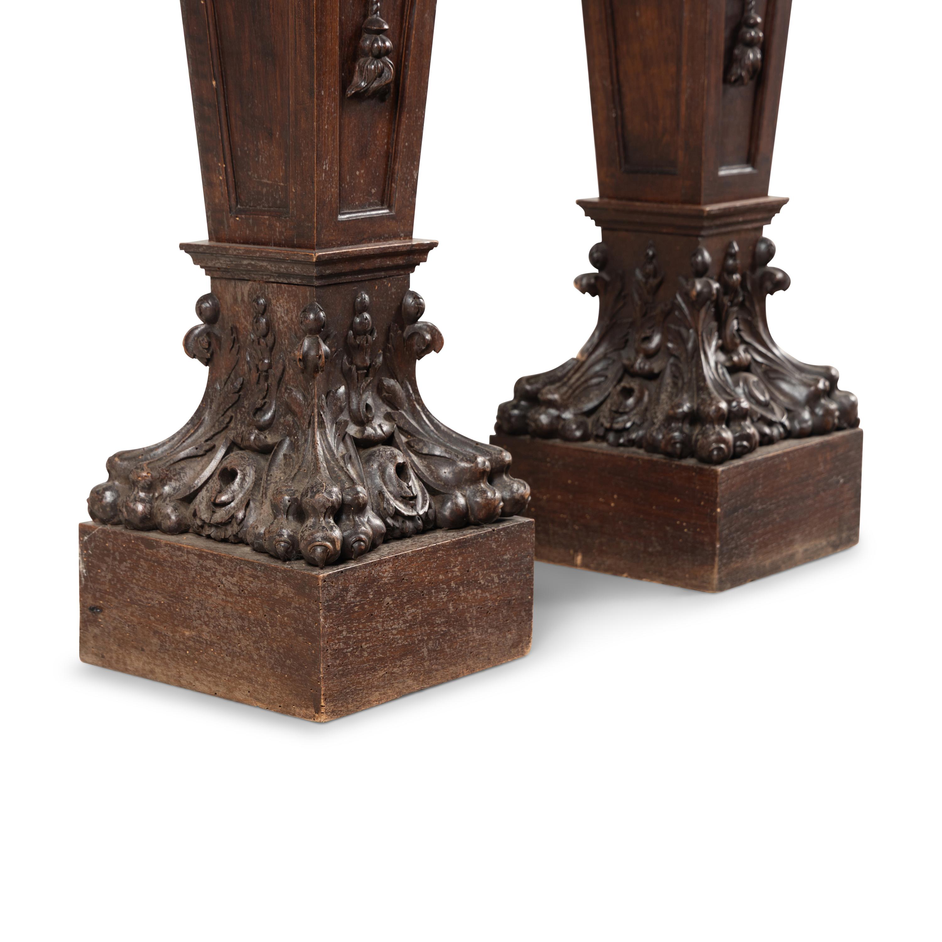 A Pair of English Carved Walnut and Marble Top Pedestals