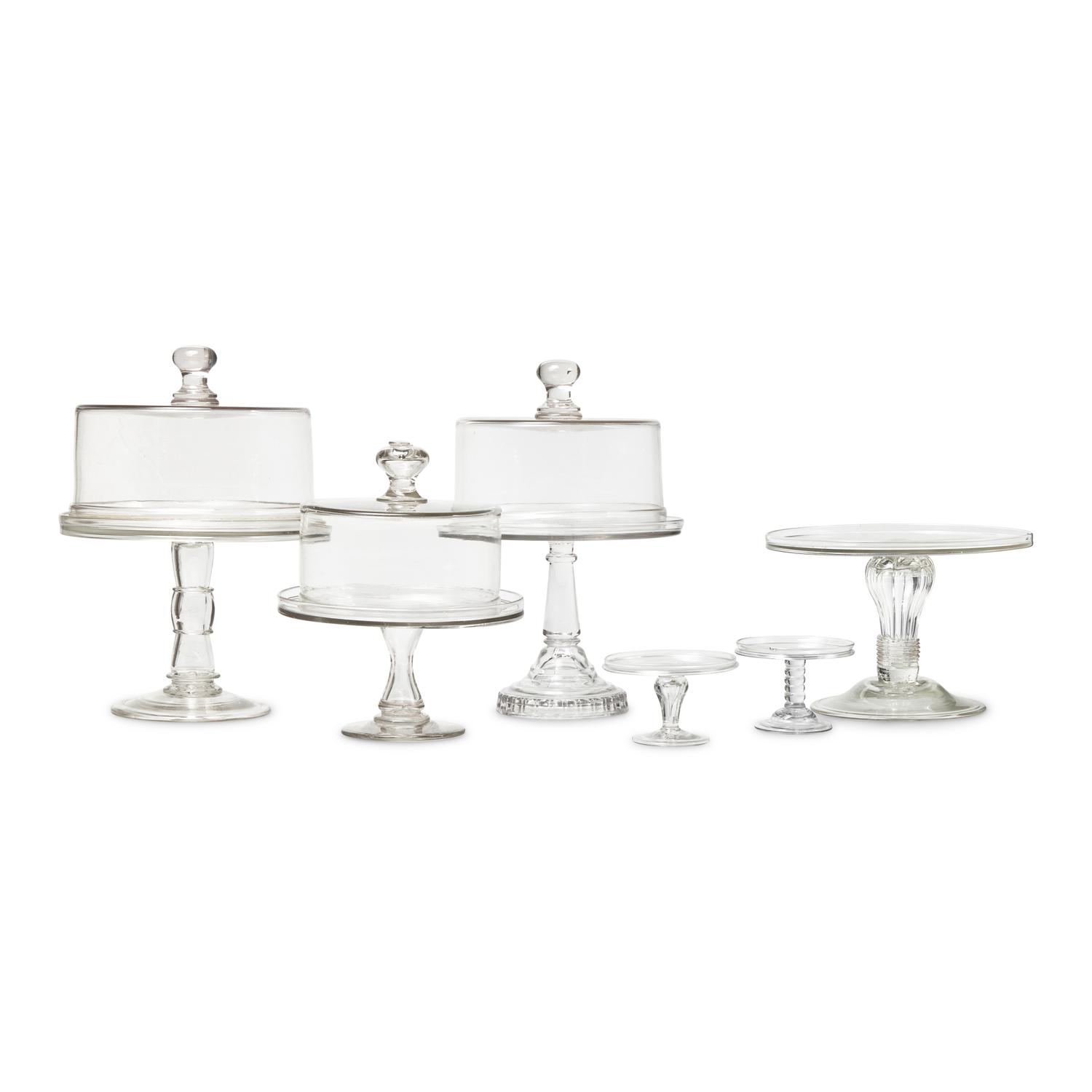 A Group of Nine Blown and Cast Glass Footed Cake Plates and Covers