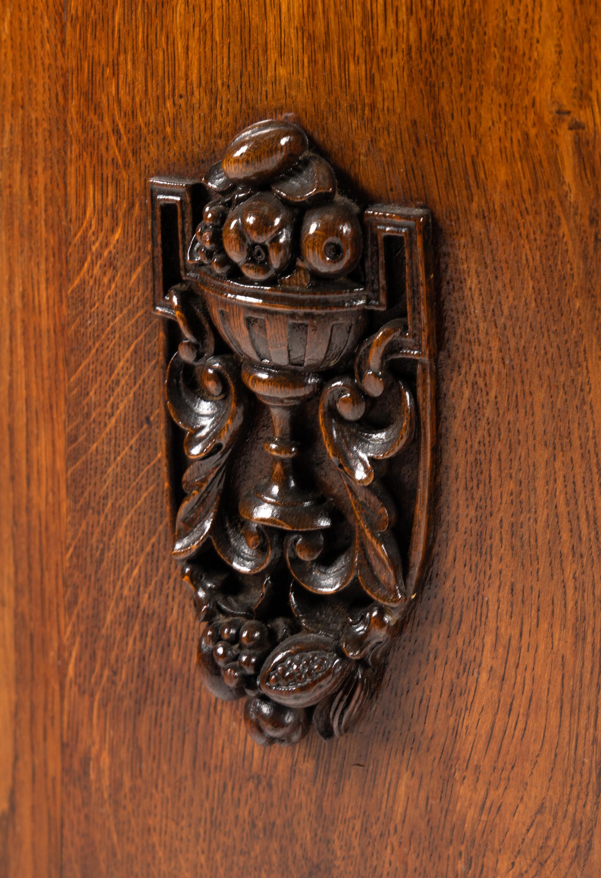 A Continental Carved Oak Demilune Cabinet