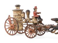 A Cast Iron Fire Engine Three-Horse Train and a Horse Pull Toy