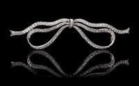An Edwardian Platinum Topped Gold and Diamond Bow Brooch, 9.10 dwts.
