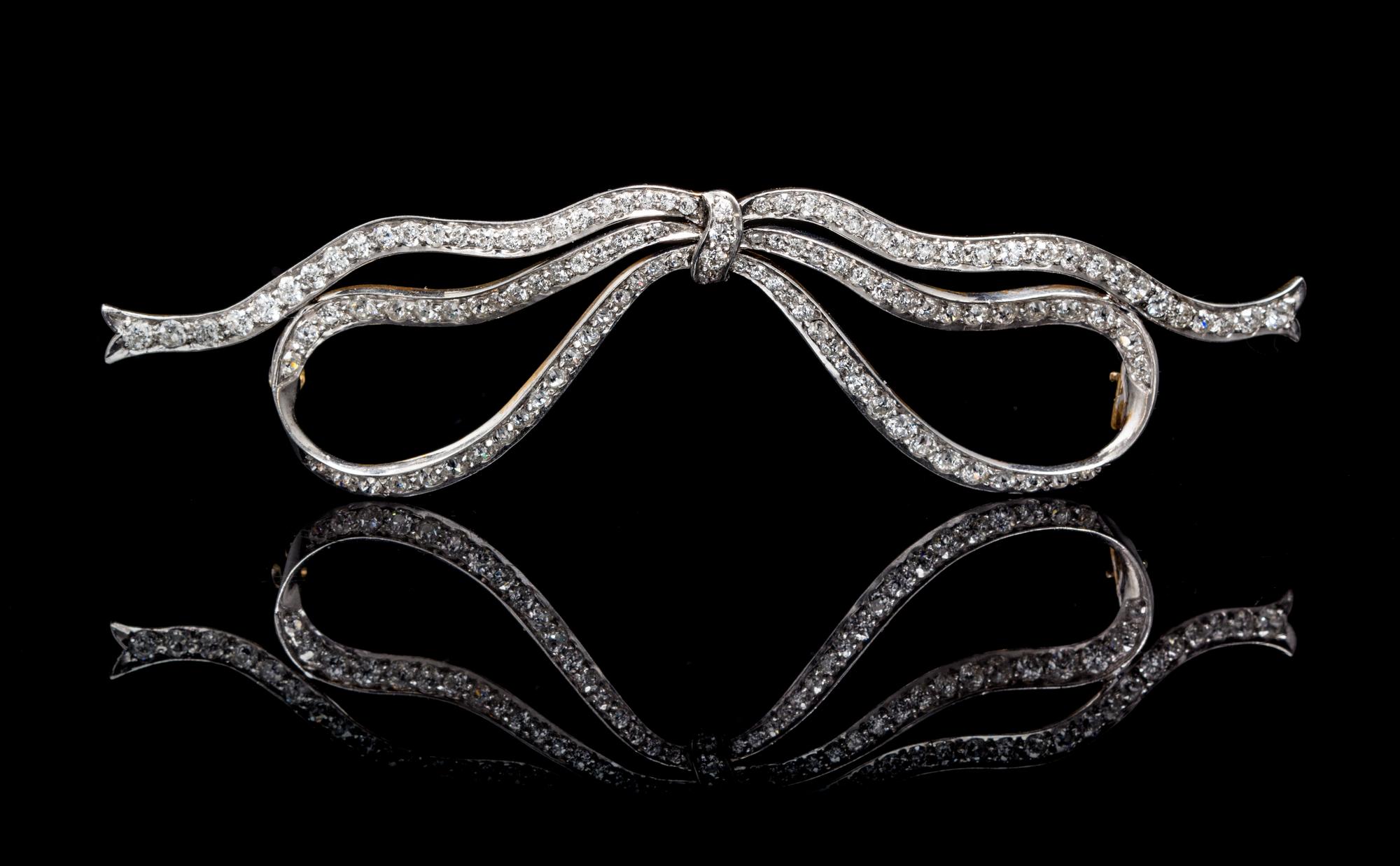 An Edwardian Platinum Topped Gold and Diamond Bow Brooch, 9.10 dwts.