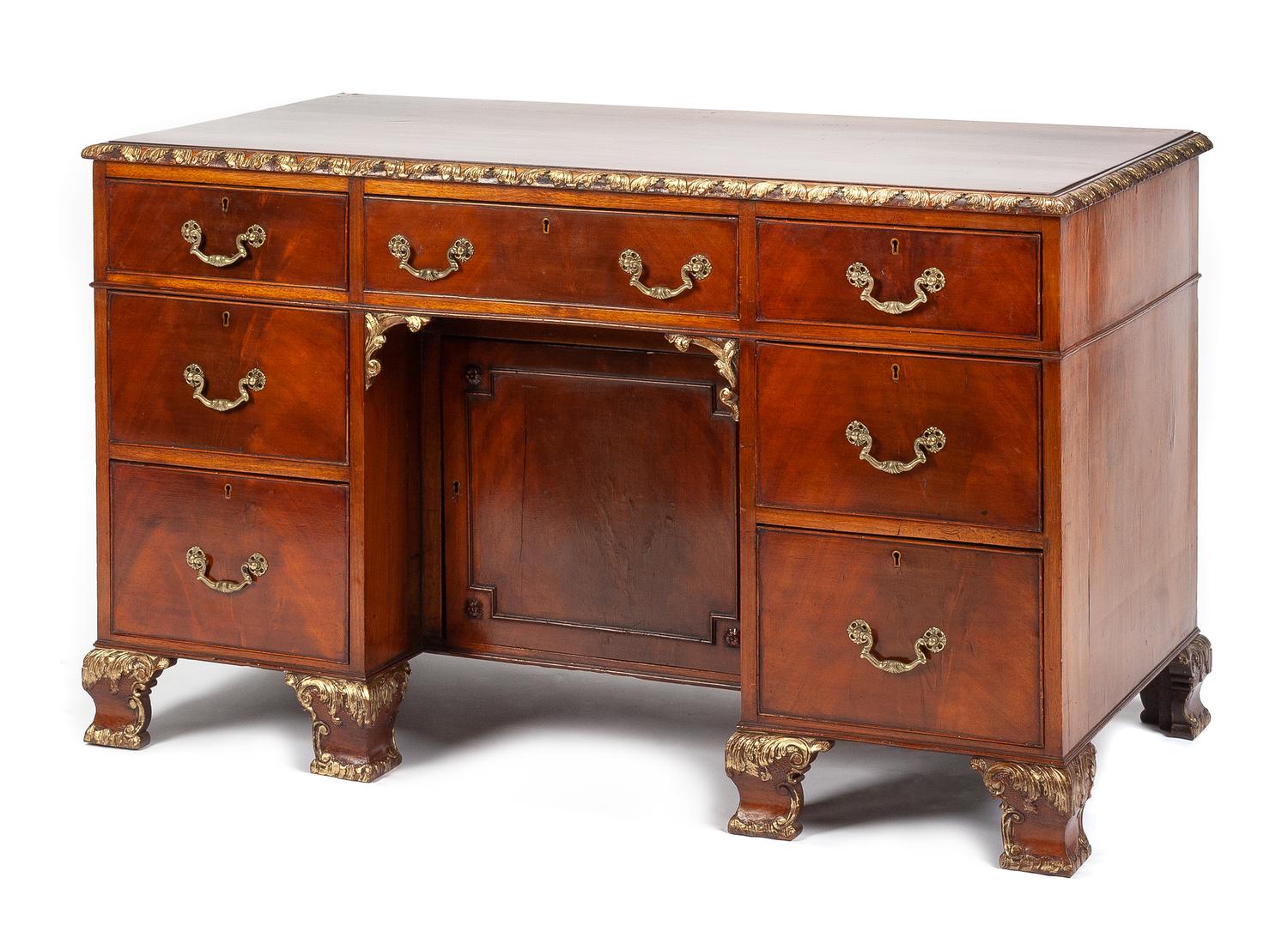 A Georgian Style Parcel Gilt Mahogany Kneehole Desk Height 29 1/4 x width 49 1/2 x depth 25 inches.