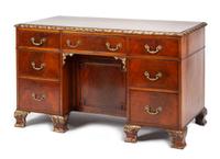 A Georgian Style Parcel Gilt Mahogany Kneehole Desk Height 29 1/4 x width 49 1/2 x depth 25 inches.
