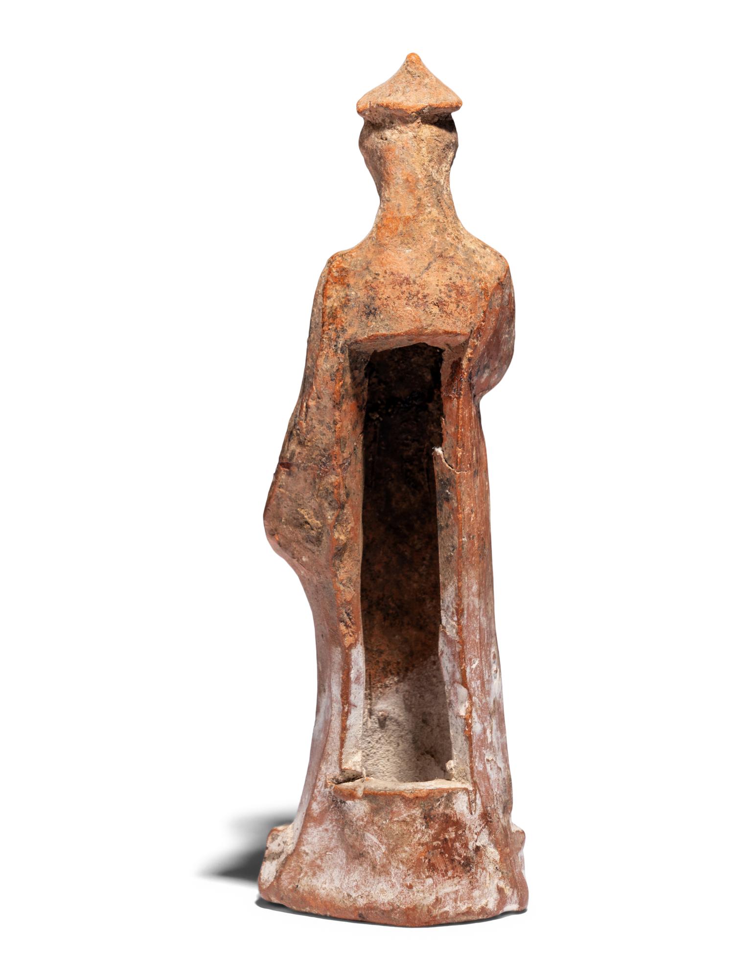 A Greek Terracotta Draped Female Figure with a Pilos