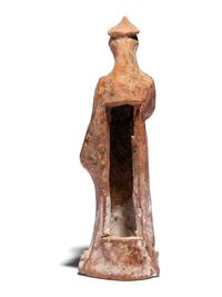 A Greek Terracotta Draped Female Figure with a Pilos