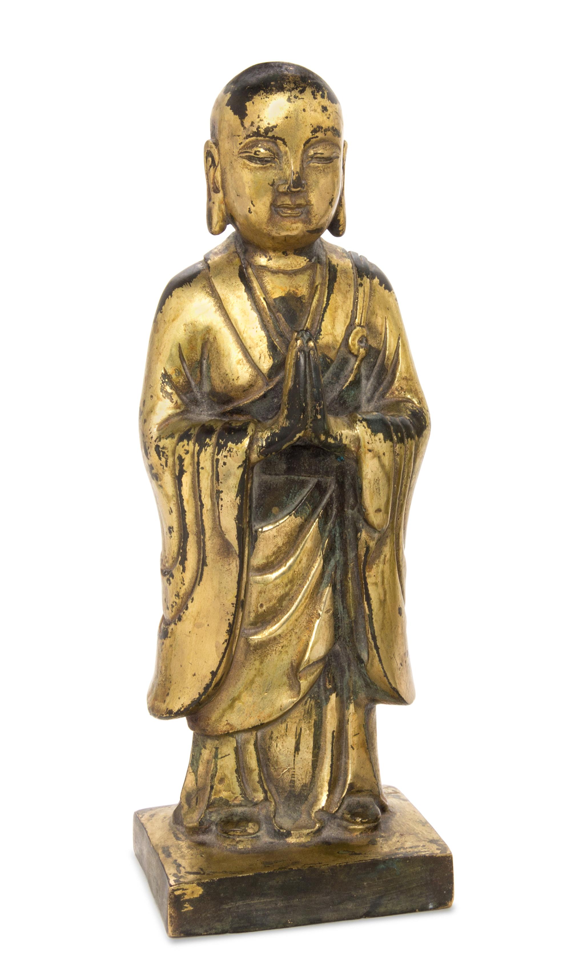 A Gilt Bronze Figure of a Standing Buddha Height 8 3/4 inches. — 19TH CENTURY