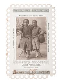 [EARLY PHOTOGRAPHY]. Advertising card for Henry Moore, Kirksville, MO, featuring two young African American subjects posed affectionately. La Plata, MO: Burns, ca 1900.