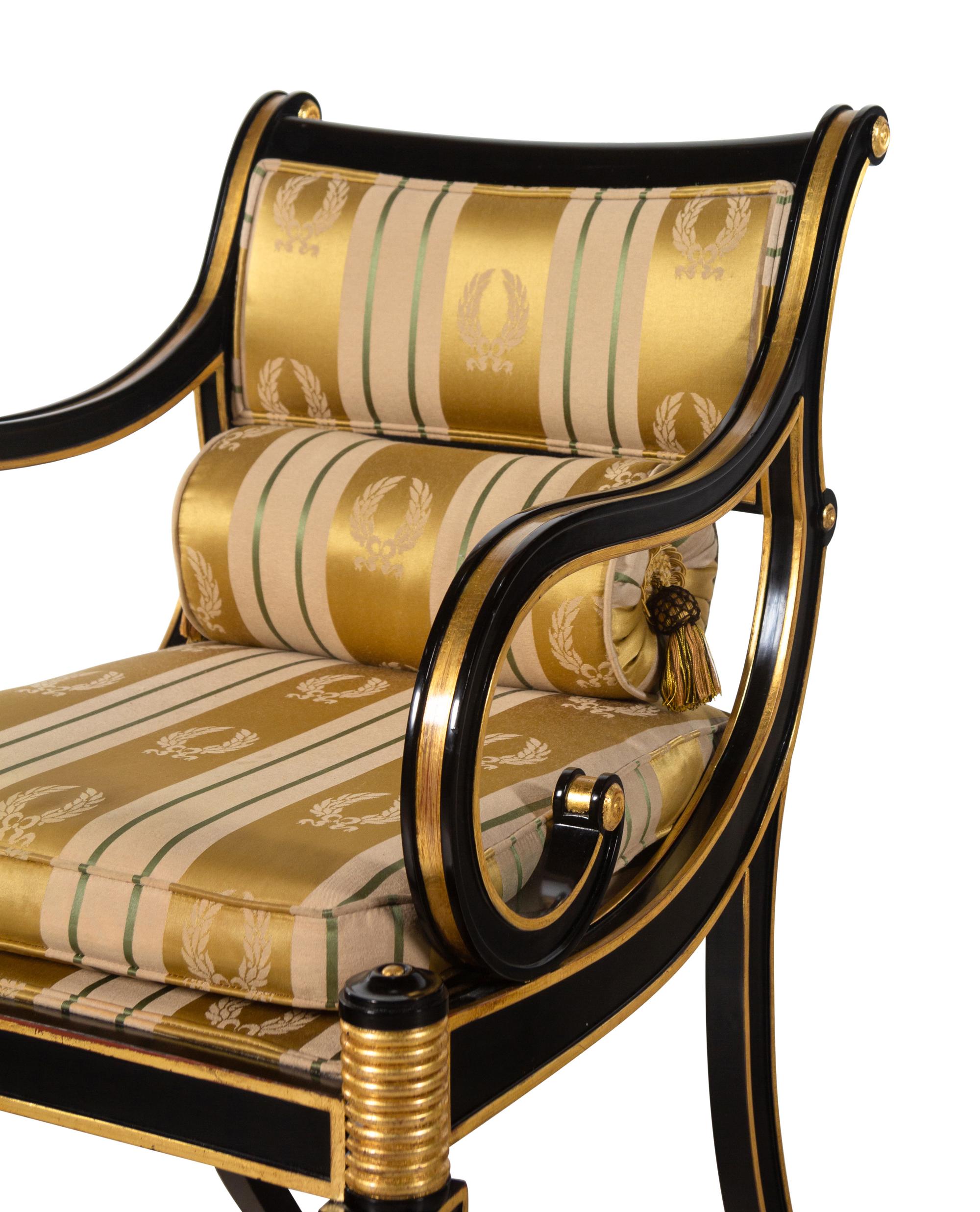 A Pair of Regency Style Parcel Gilt and Ebonized Armchairs