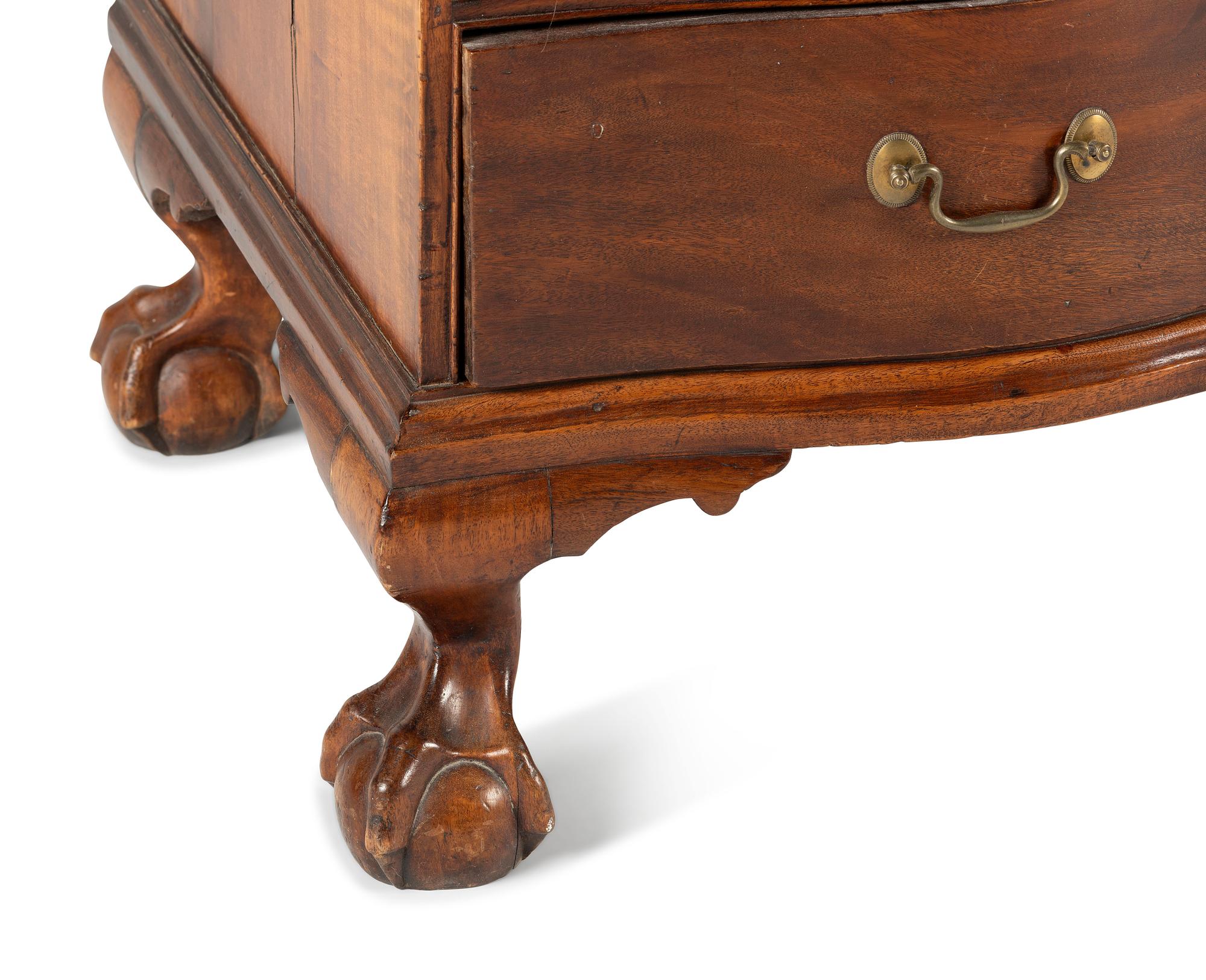A Chippendale Mahogany and Cherrywood Serpentine Claw-and-Ball Foot Desk-and-Bookcase
