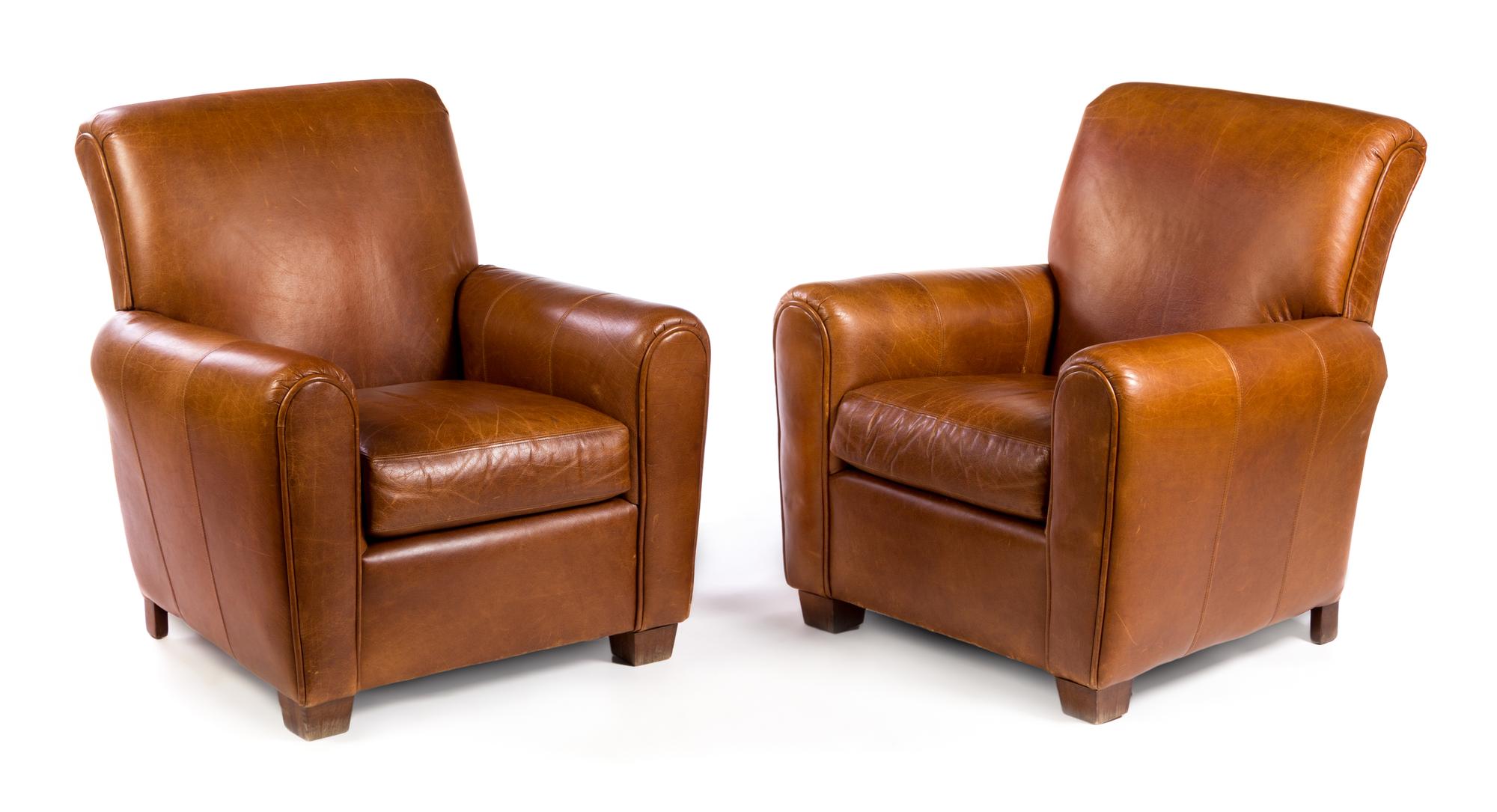 A Pair of Leather Upholstered Club Chairs Height 39 x width 29 x depth 37 inches.