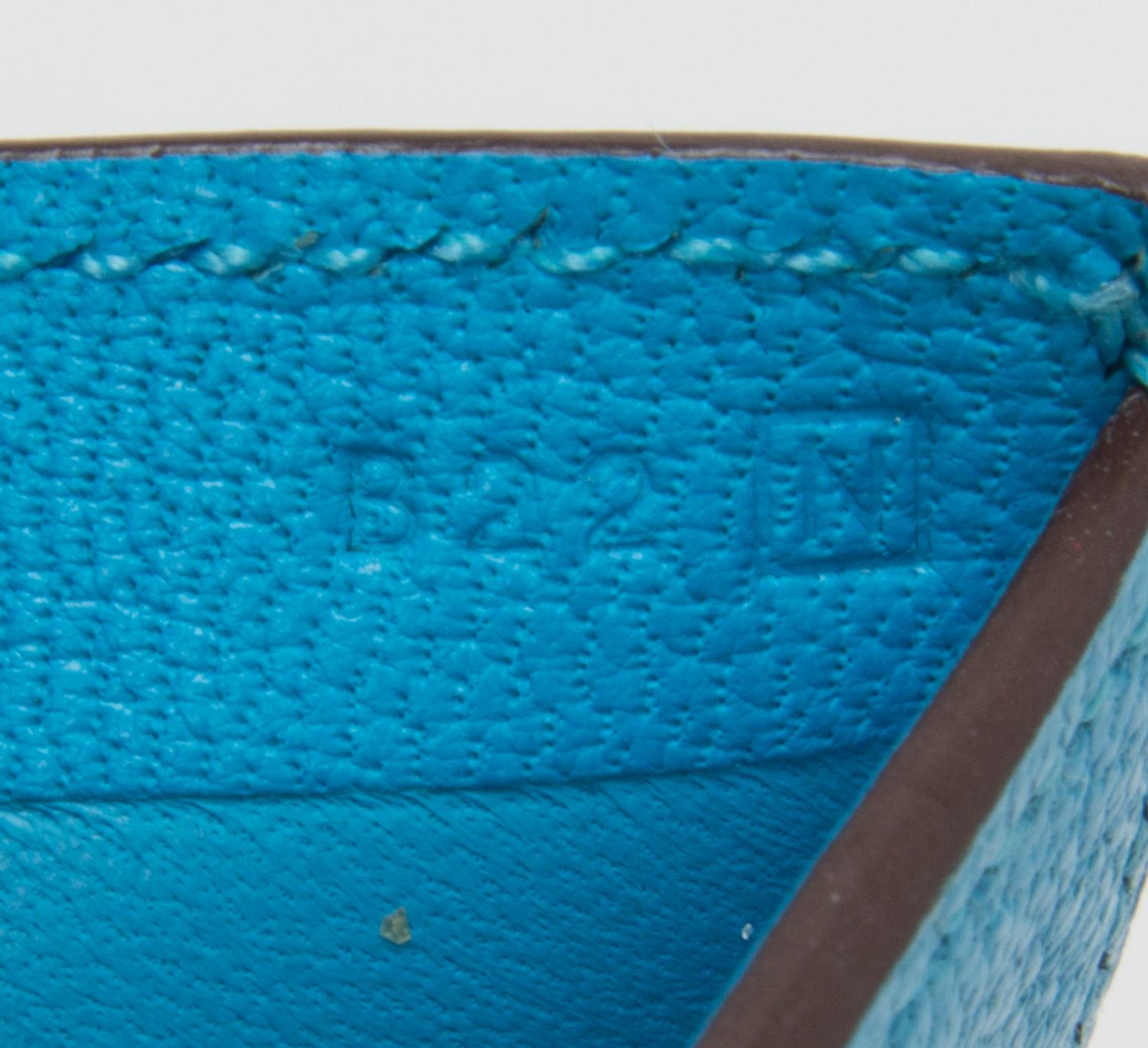 An Hermes Saint Cyr Blue Leather Evelyne Wallet, 4" x 4" x .25".